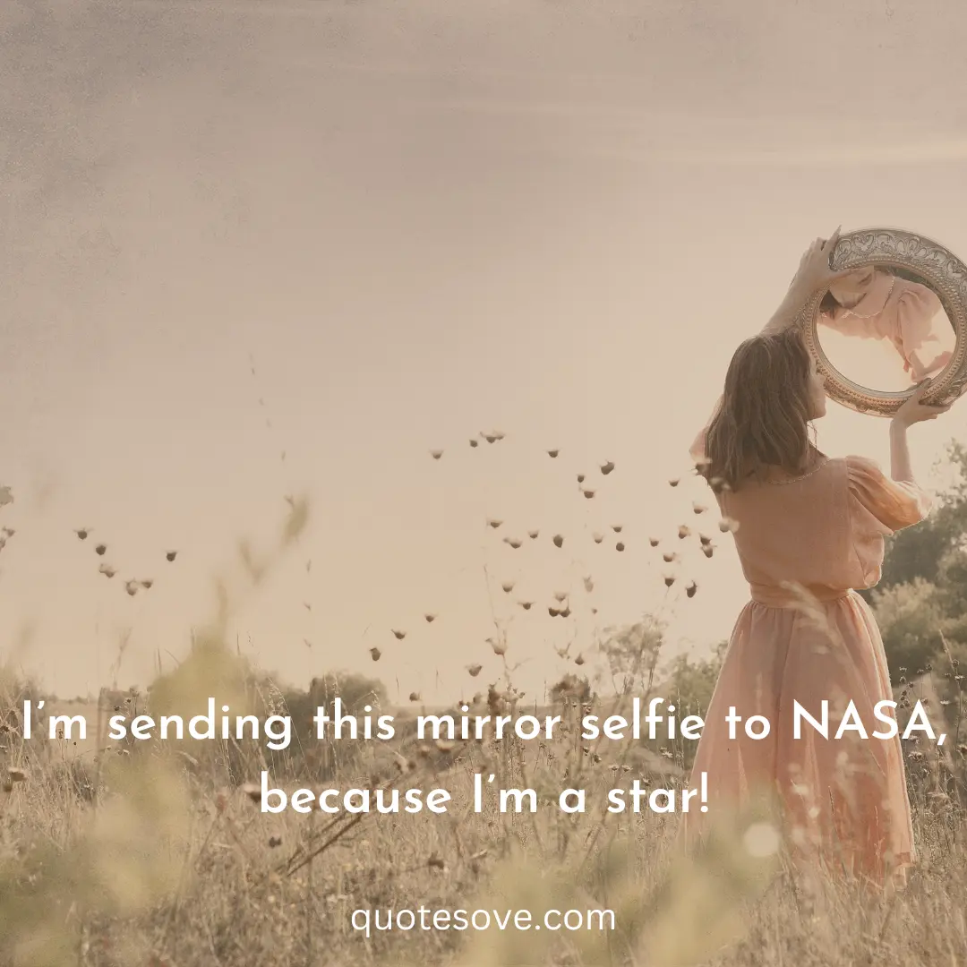 A girl standing holding a mirror